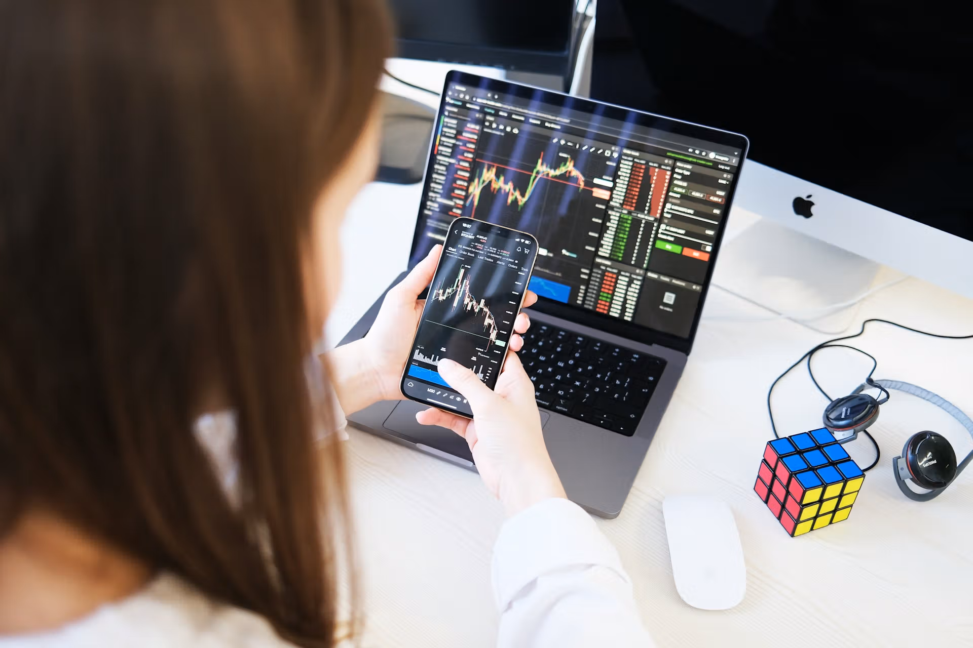 Crypto trader on laptop and phone 