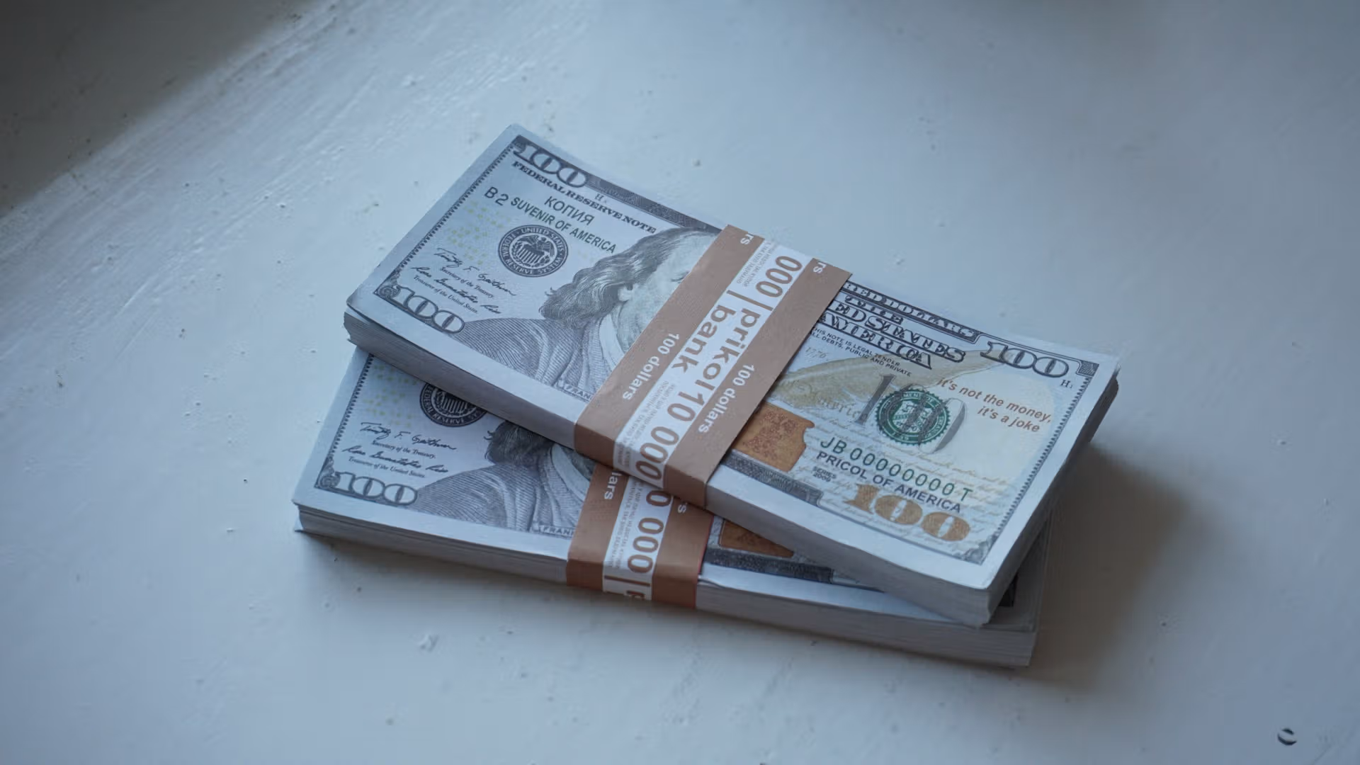 Stacks of 100 dollar bills (Dmytro Glazunov/Unsplash/Modified by CoinDesk)