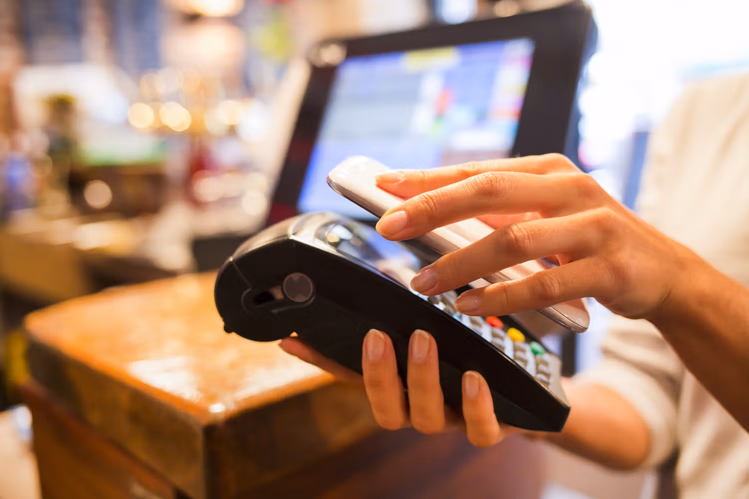 A cellphone held near a card reader (NFC)
