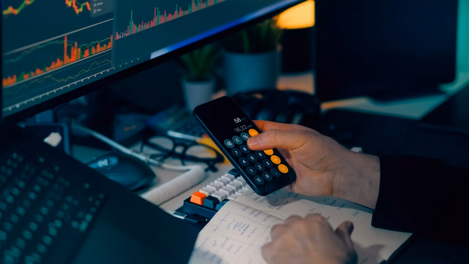 Calculator next to price charts. (Jakub Żerdzicki/Unsplash)